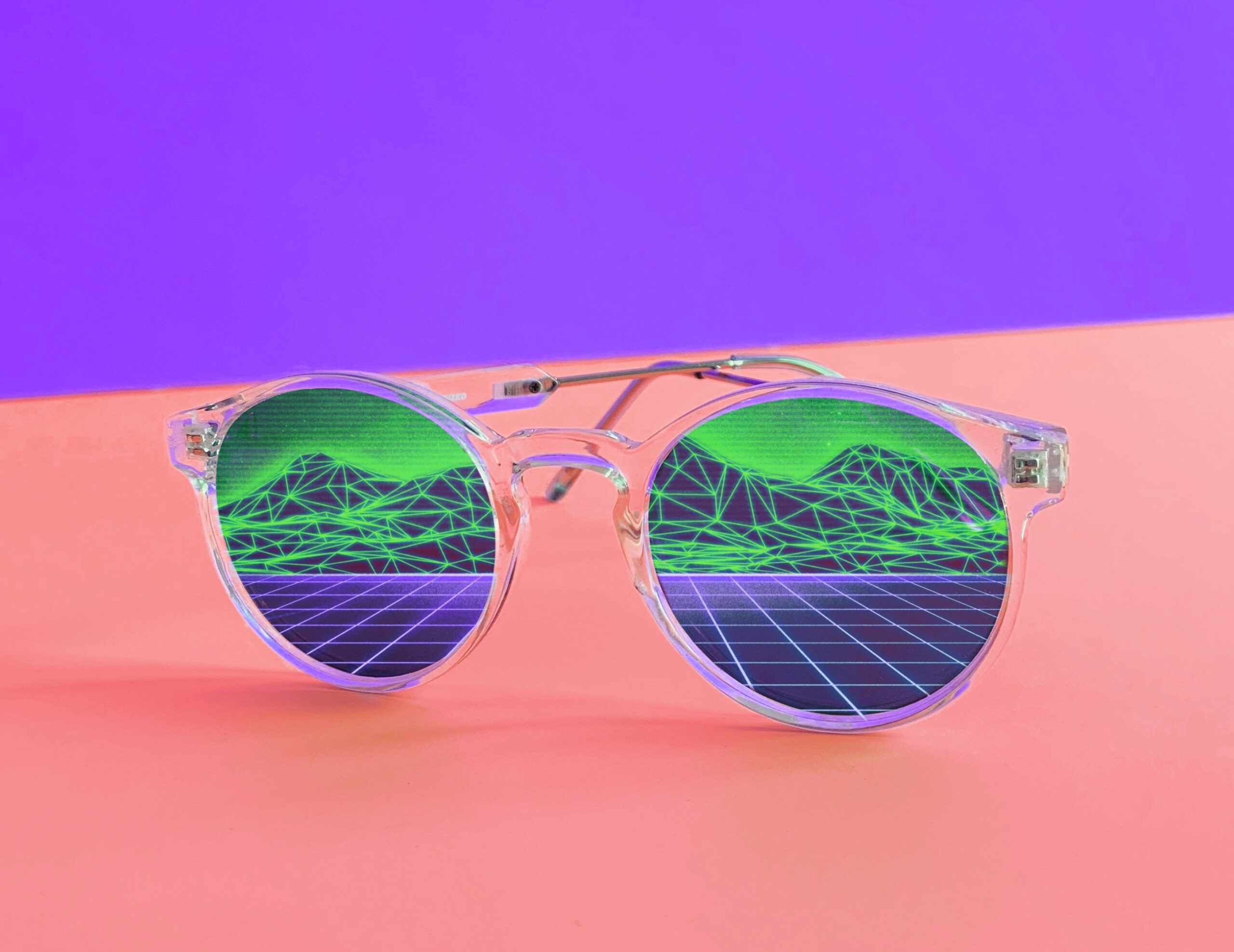 An image of sunglasses reflecting a digital landscape