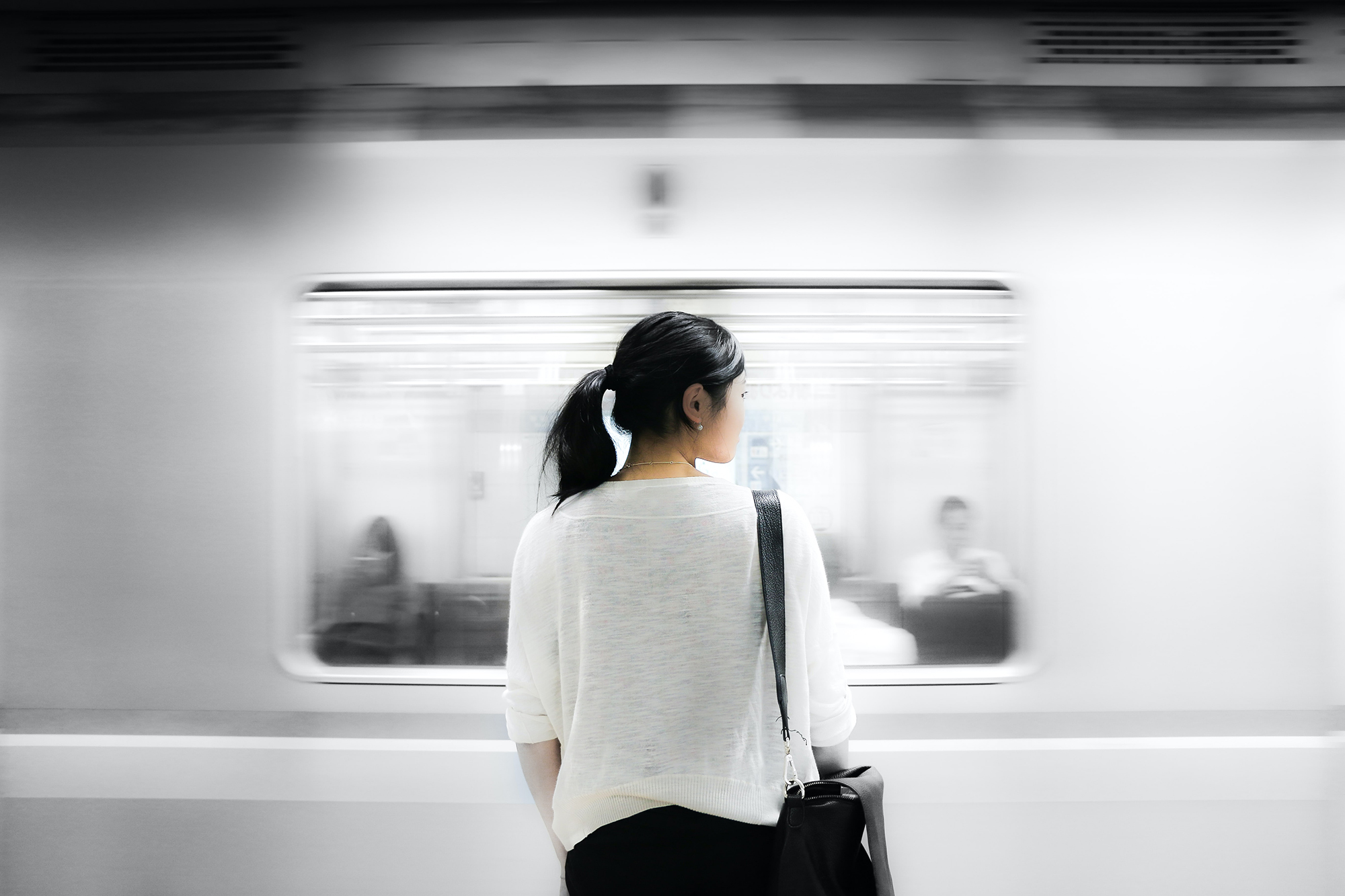 A woman in front of a subway train