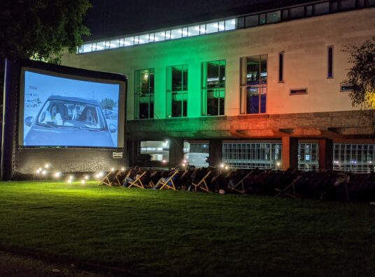 An image of deckchairs and a large screen at the CRASSH film festival.