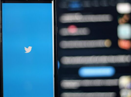 A phone showing Twitter