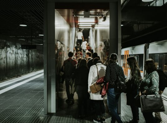 A crowd going up an escalator