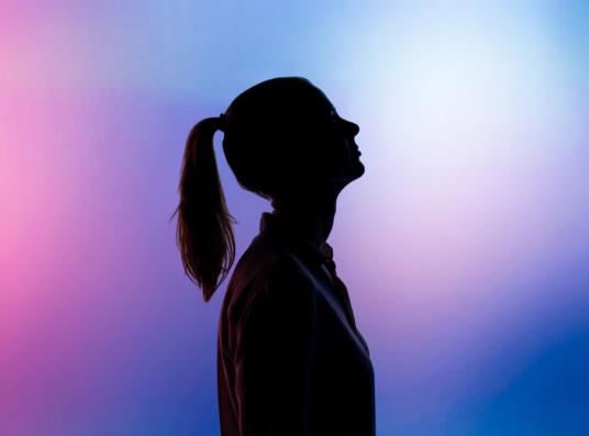 A woman in front of a gradient