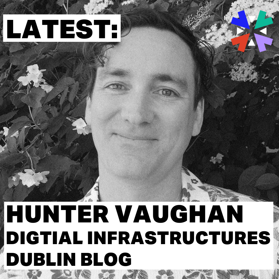 A black and and white photo of Hunter Vaughan, he has short hair with a slightly curly fringe. He is standing in front of a blossoming free, and wears a floral pattern shirt. Caption reads: Latest. Hunter Vaughan, Digital Infrastructures Dublin Blog.